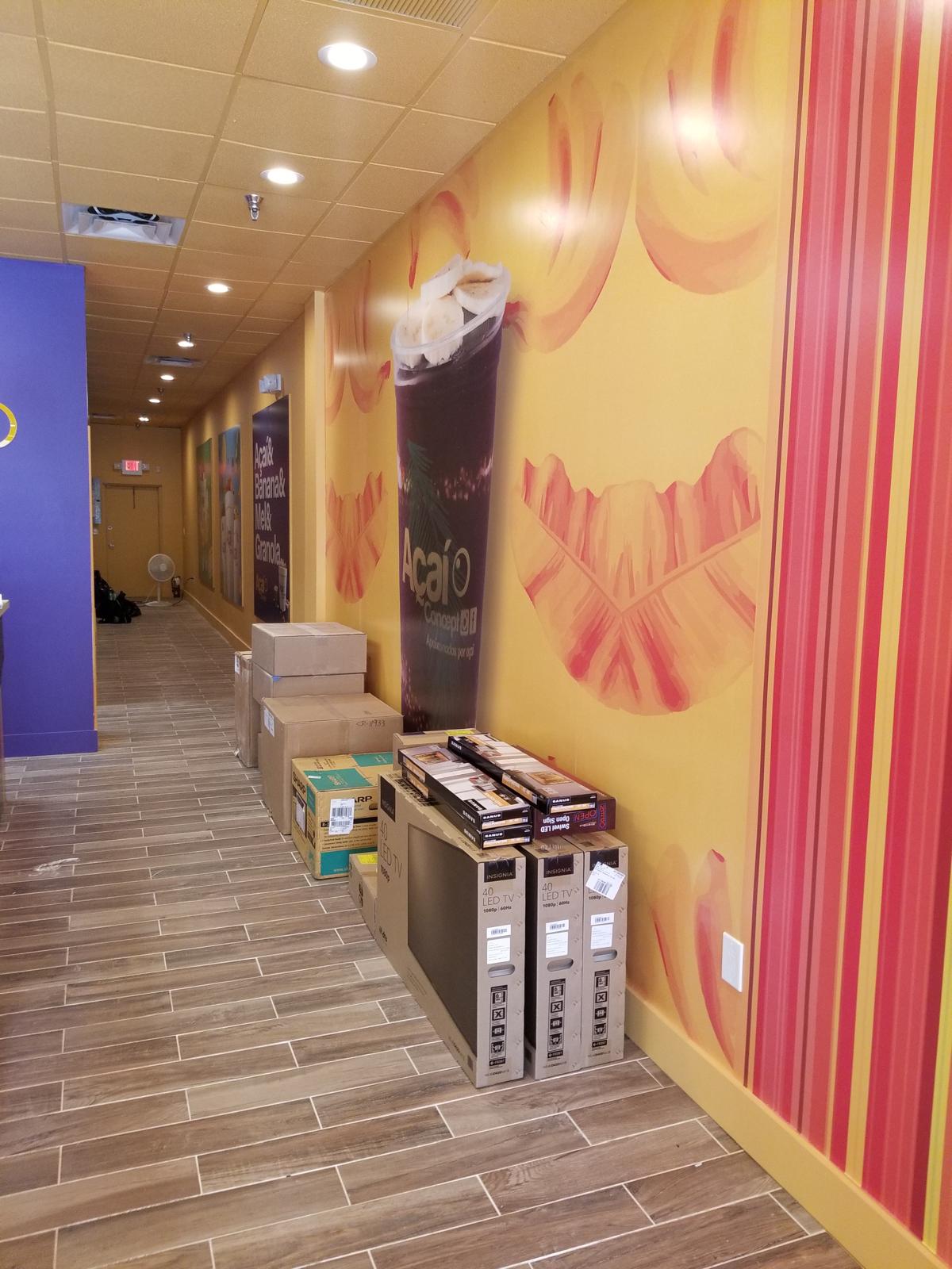 Branded corridor with printed wall graphics and commercial wood-look tile flooring