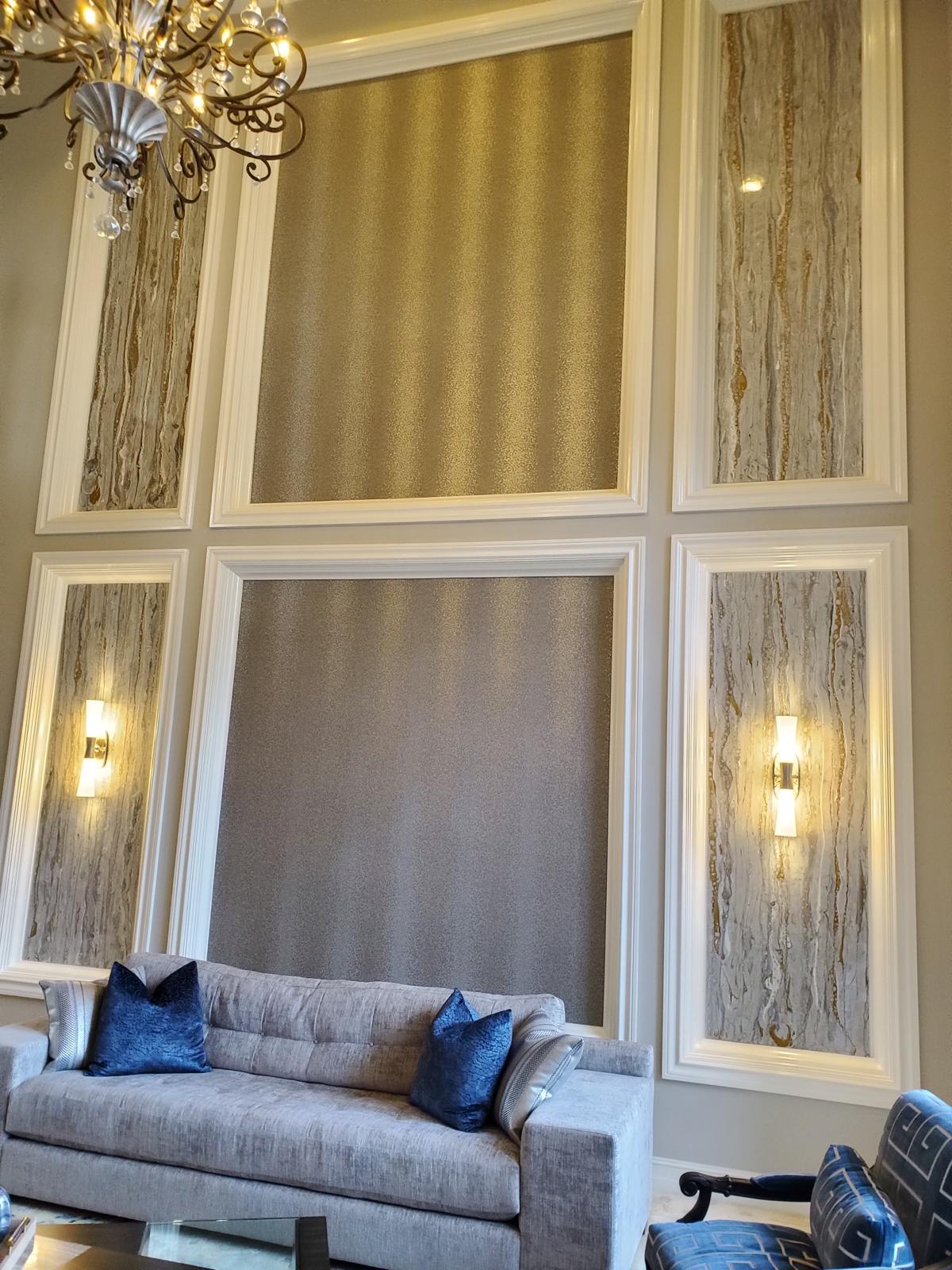 Framed accent panels with metallic wallcovering, stone inserts and wall sconces