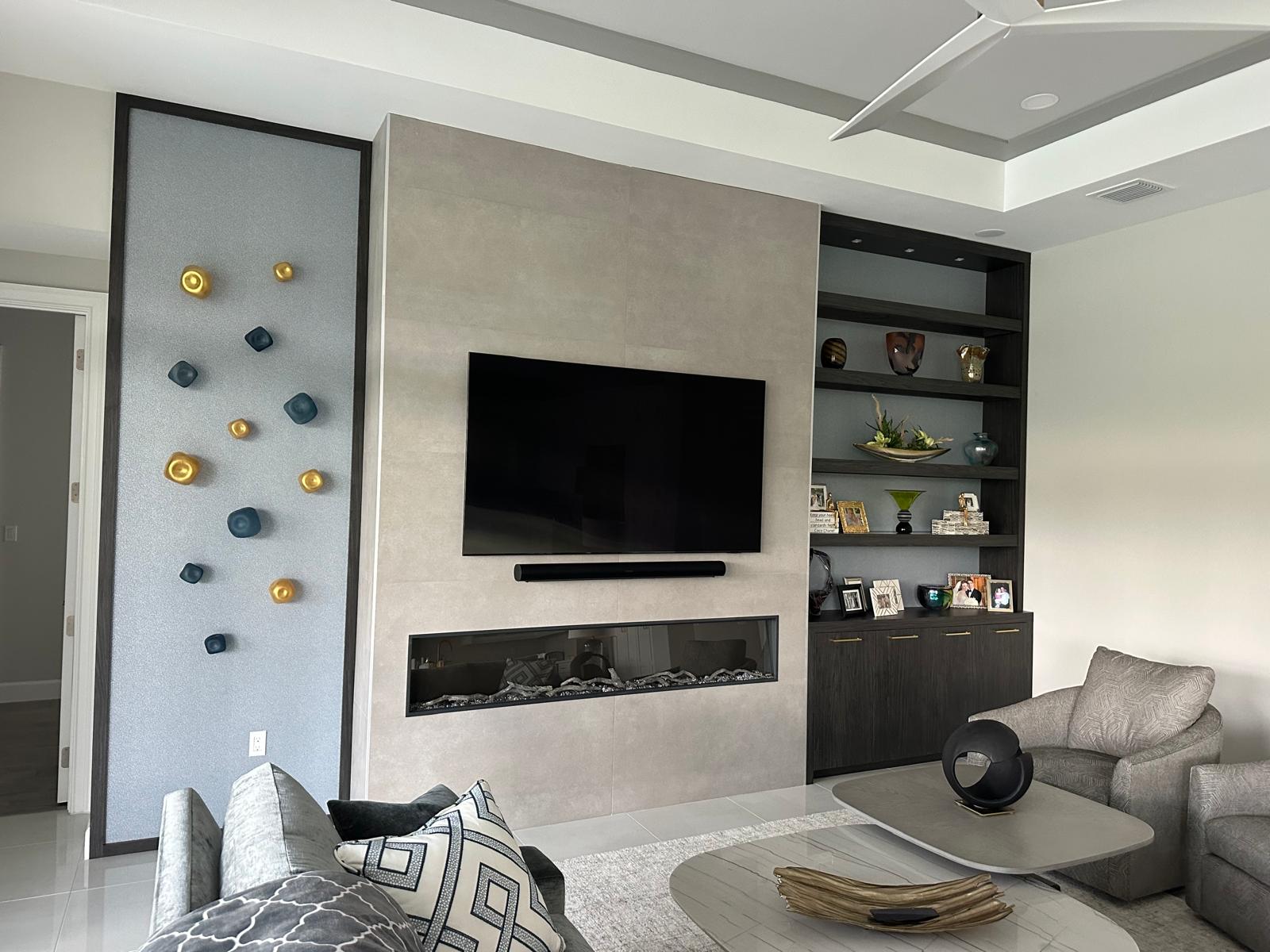 Modern family room with large-format porcelain feature wall and built-in shelving